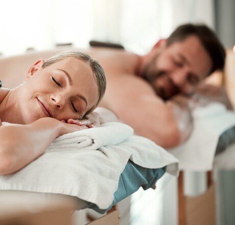 Relax couple, spa stone back massage and luxury wellness for zen therapy, beauty and rich skincare. Calm, peace and sleeping people on salon bed for healthy stress relief or happy holistic body detox